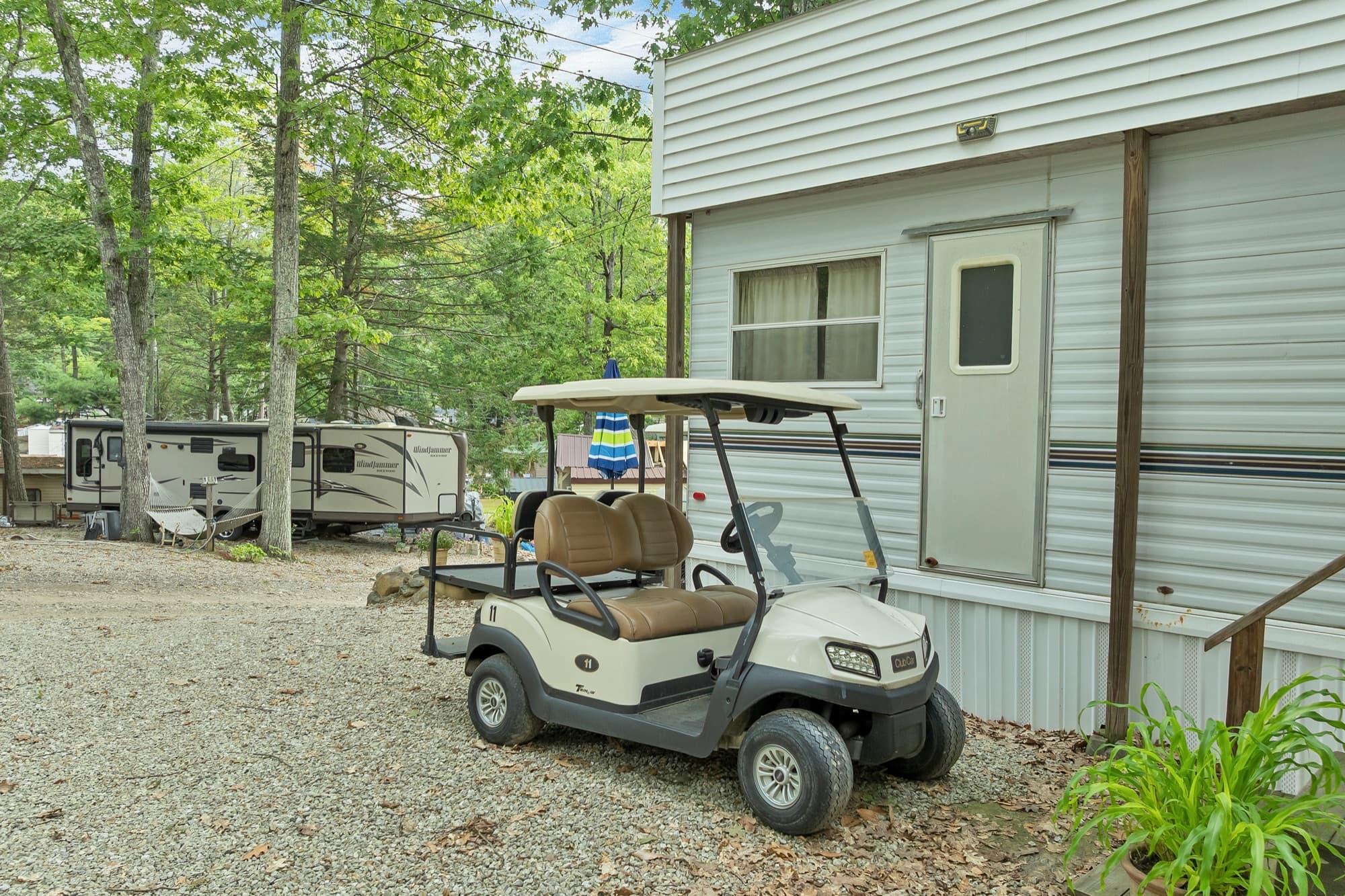 The electric golf cart parked beside the unit's side door