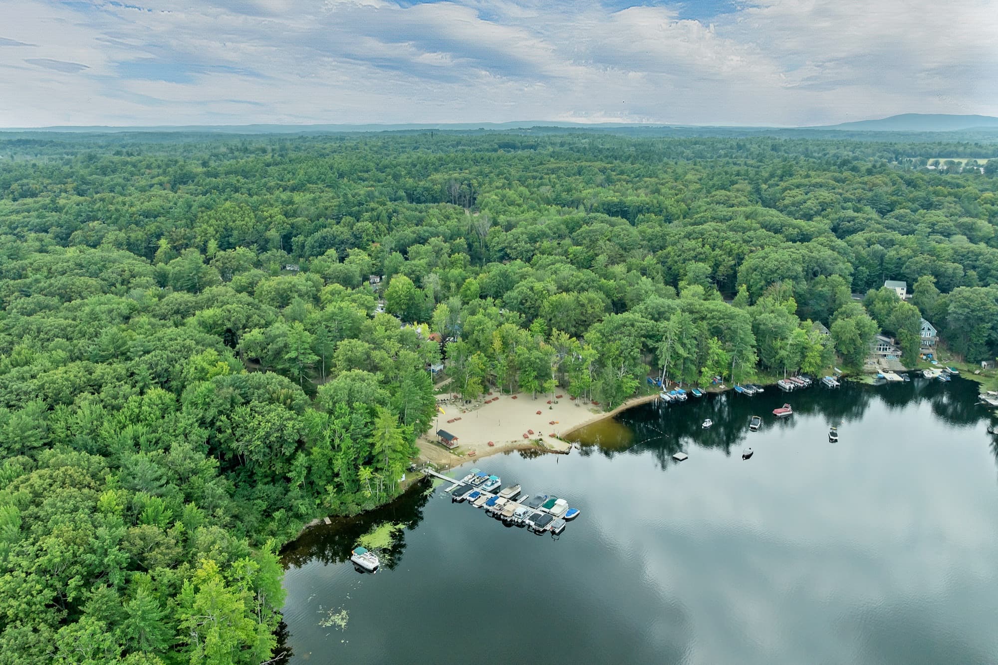 Aerial view of the community beach, the docks, and the boats